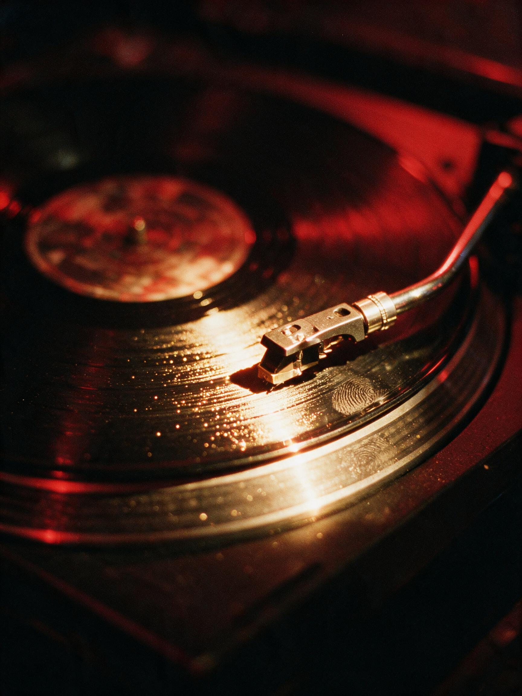 The needle on the vinyl in the booth